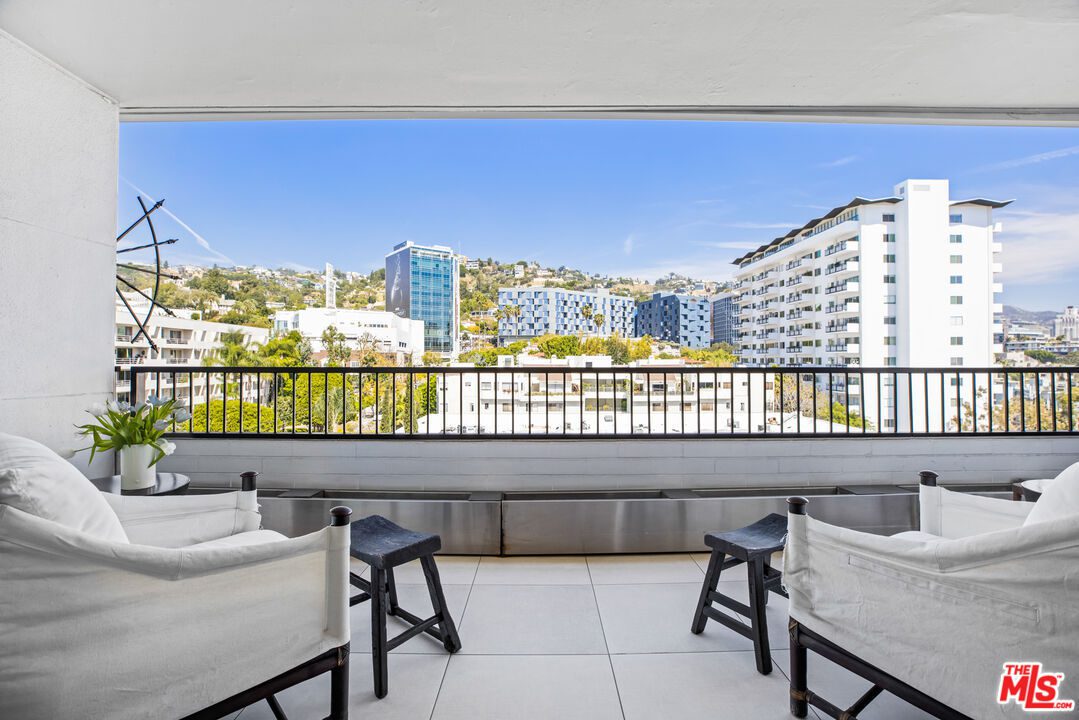 A balcony with two chairs and a table