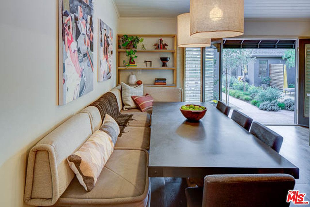 A dining room with a long table and chairs