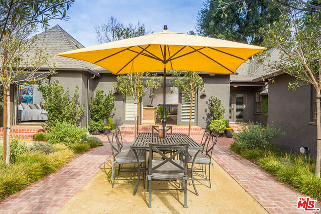 A patio table with chairs and an umbrella.