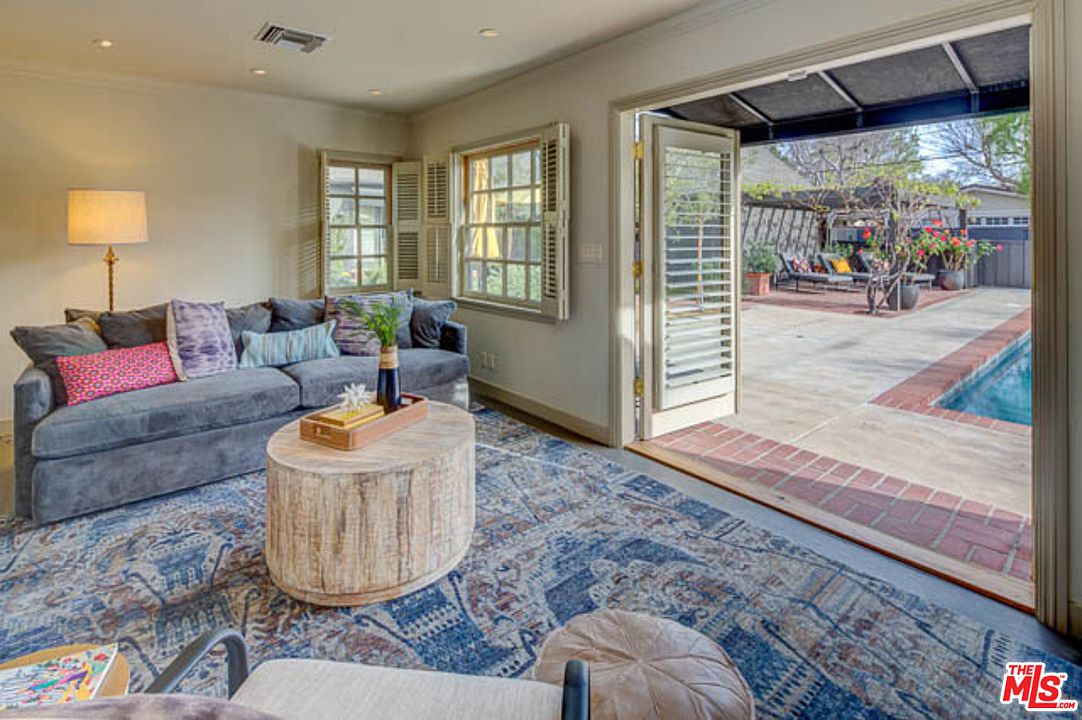 A living room with a couch and chairs in it