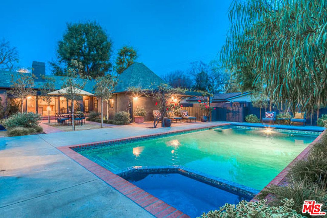 A pool with lights on in the background