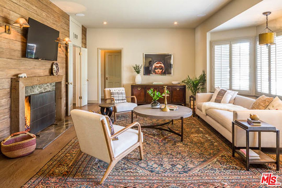 A living room with couches, chairs and a coffee table.