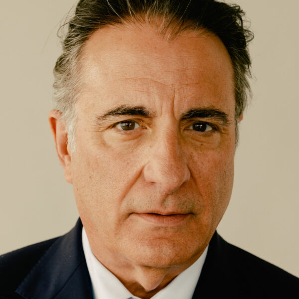 A man in suit and tie looking at the camera.