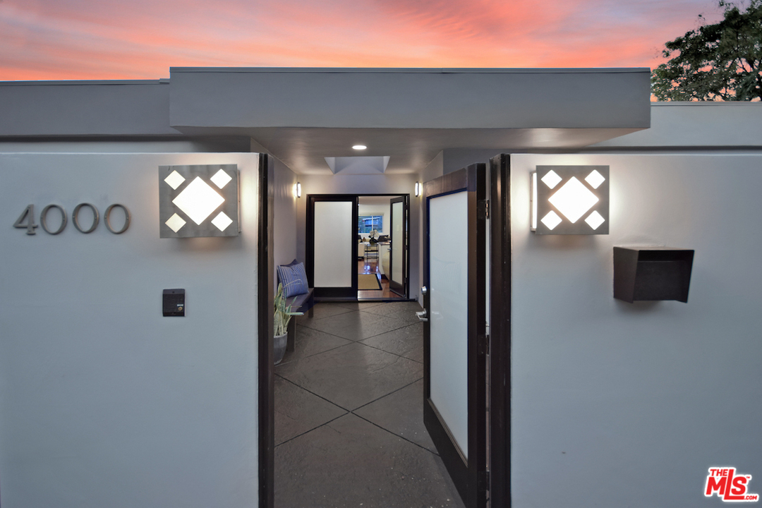 A hallway with two lights and a door way.