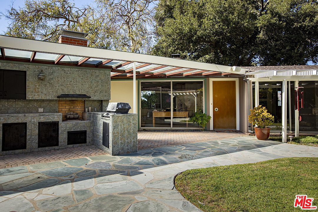 A patio with an outdoor grill and barbecue.