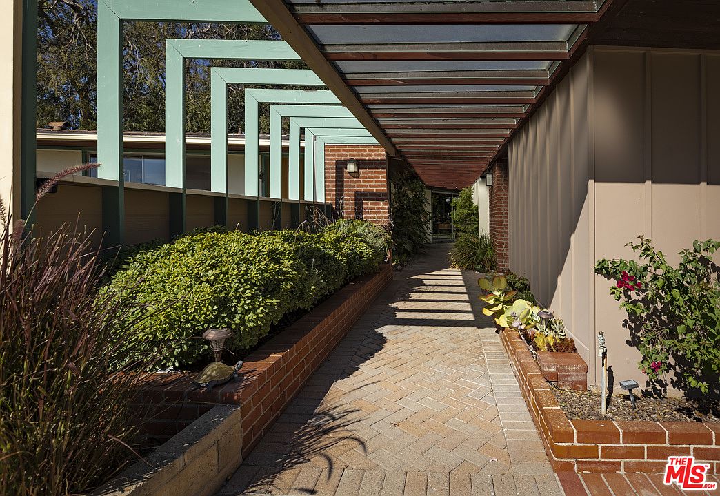 A walkway with plants and flowers in it.