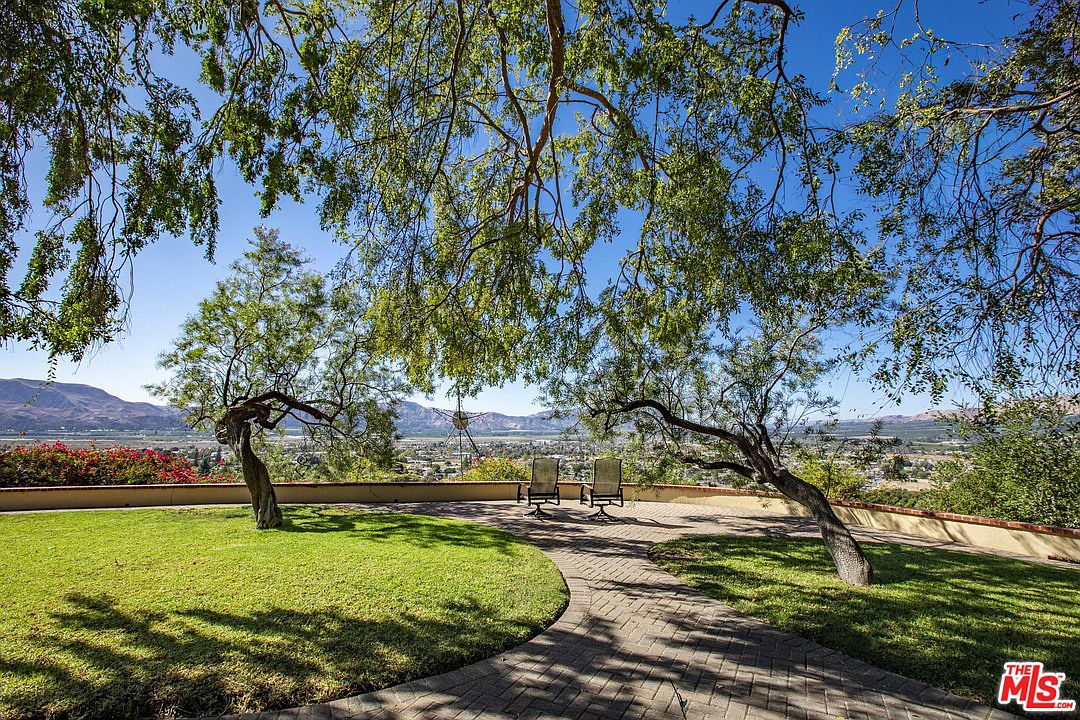 A park with trees and benches in the background.