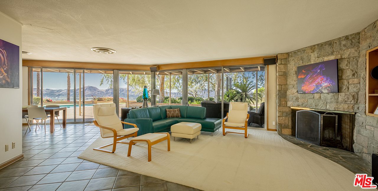 A living room with couches and chairs in it