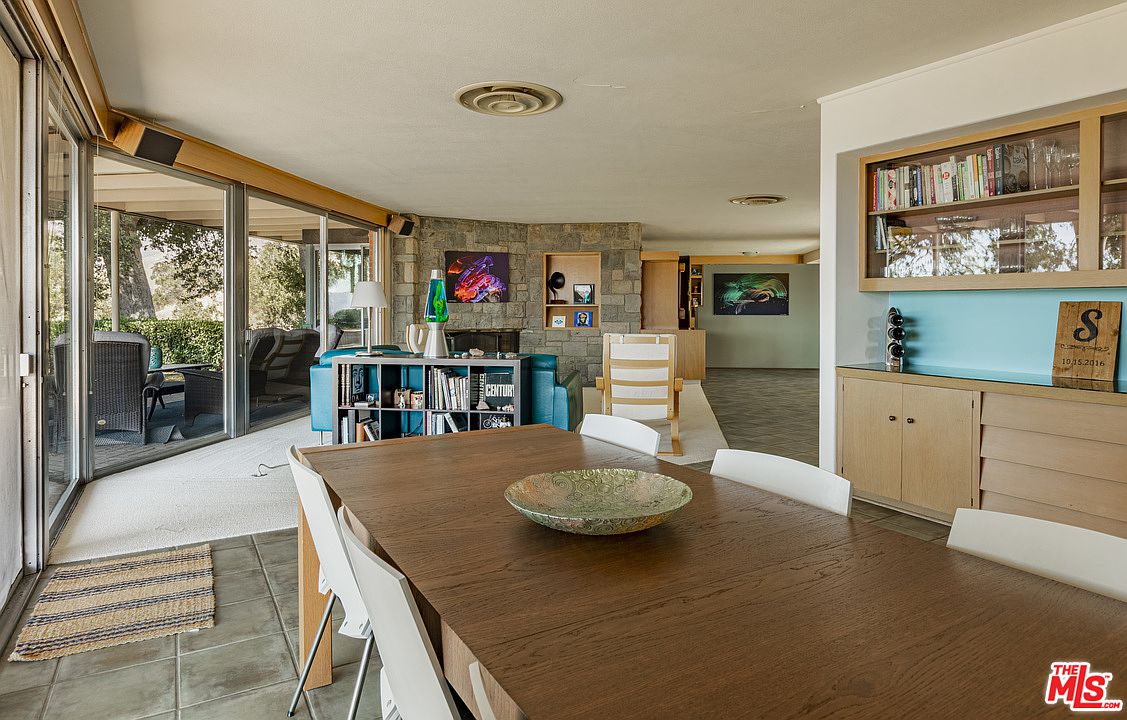 A dining room table with chairs and a bowl on it.