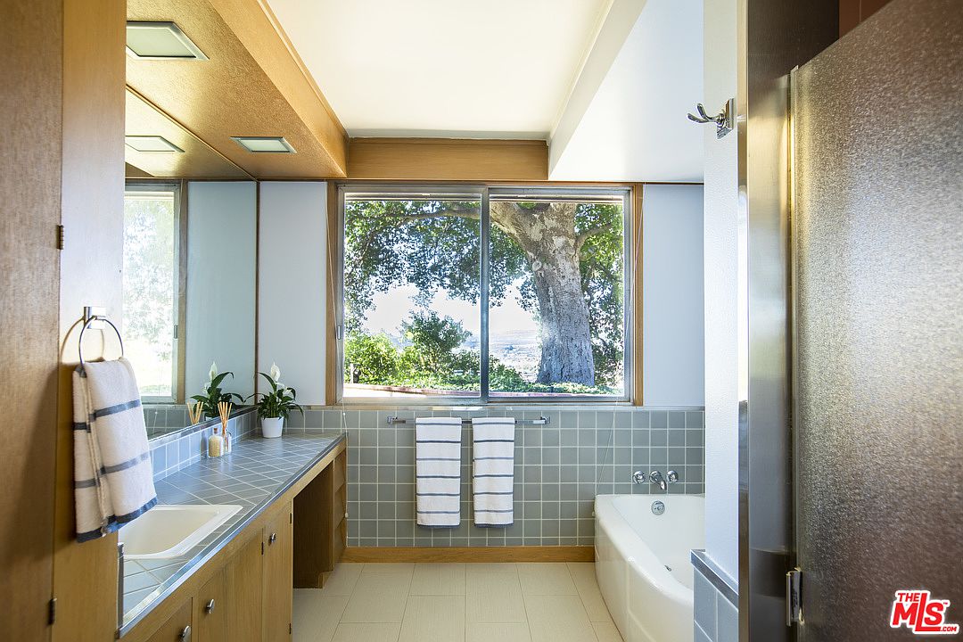 A bathroom with a tub and sink in it