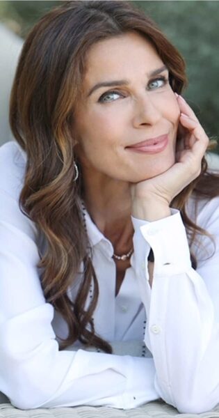 A woman with long hair and wearing a white shirt