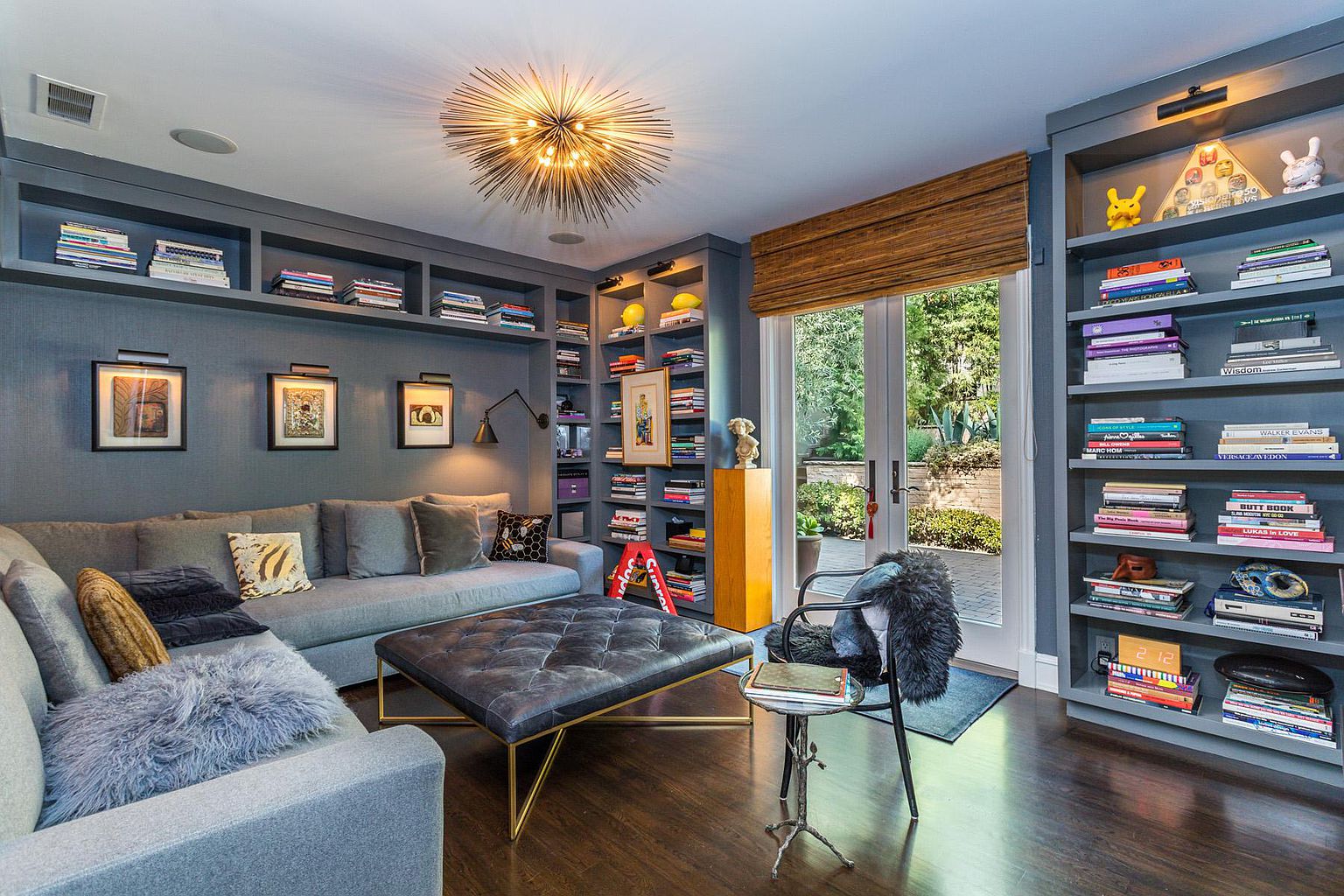 A living room with many books and pictures on the wall