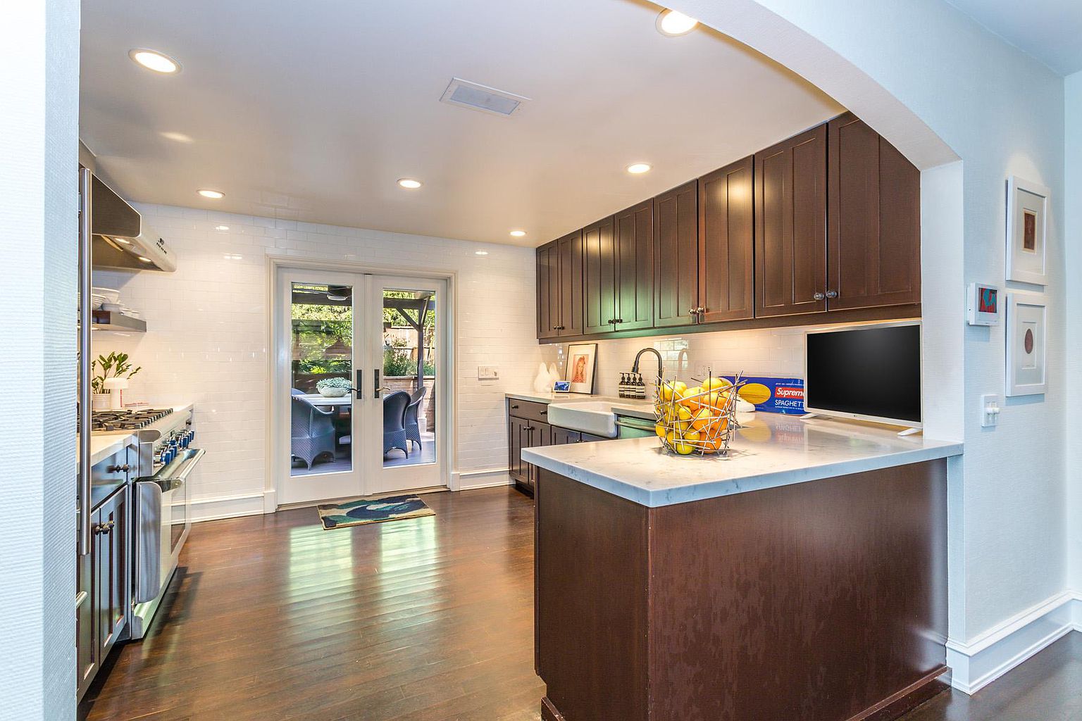 A kitchen with wooden cabinets and white counter tops.