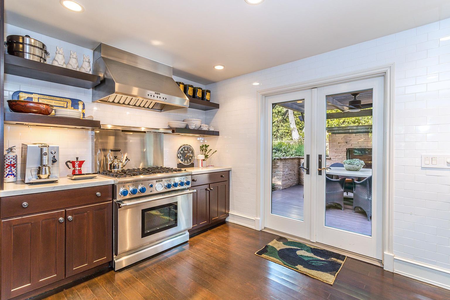 A kitchen with wooden floors and white walls.