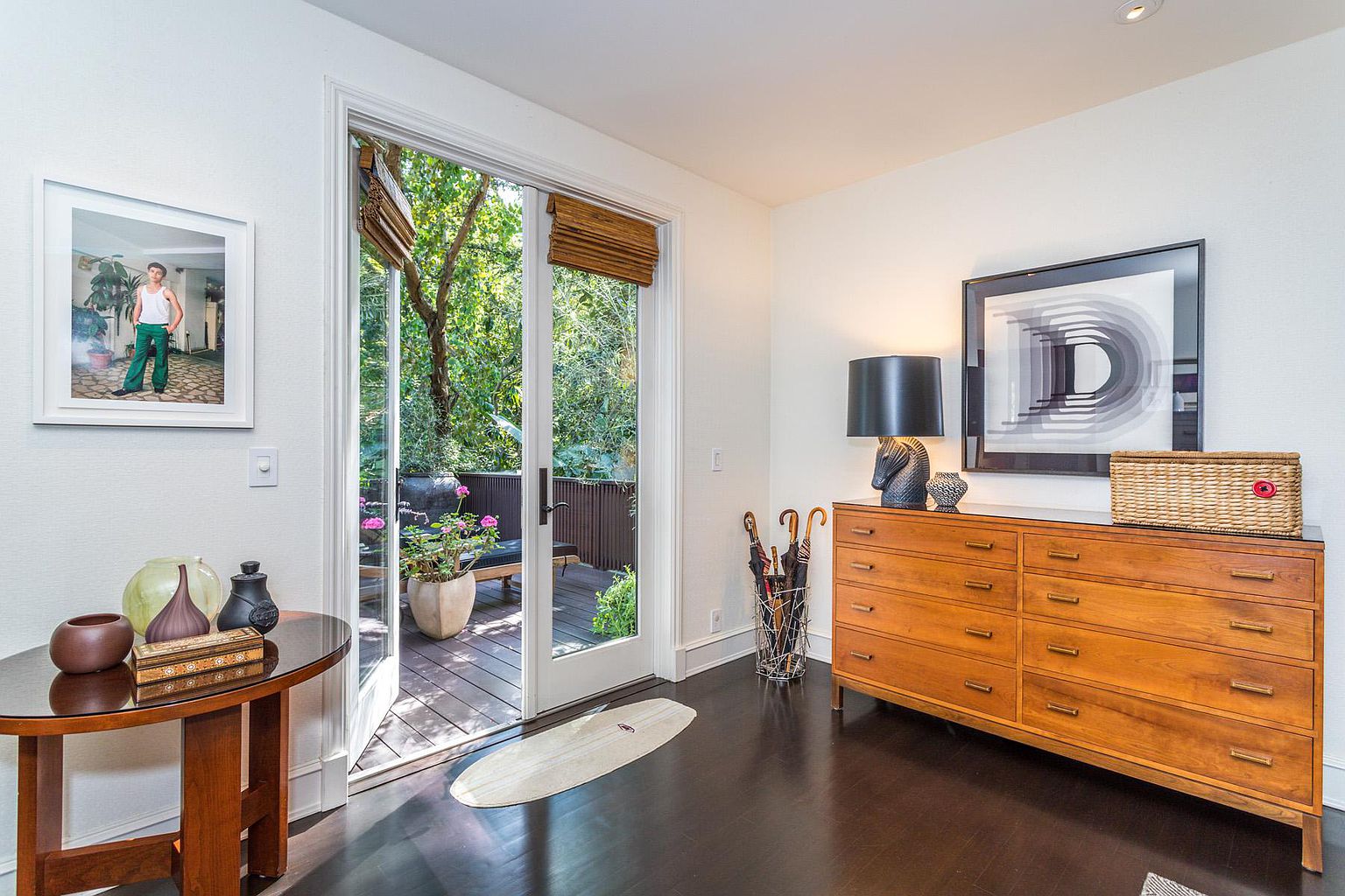 A room with a large sliding glass door and hardwood floors.