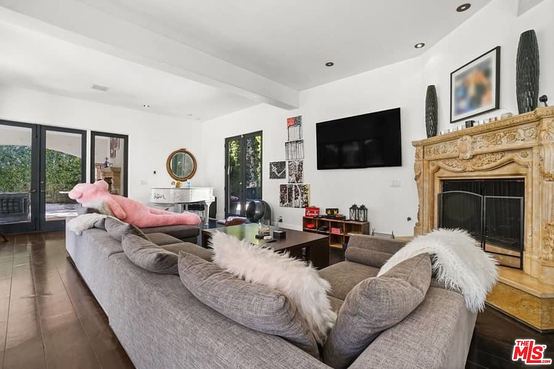 A living room with couches and a fireplace