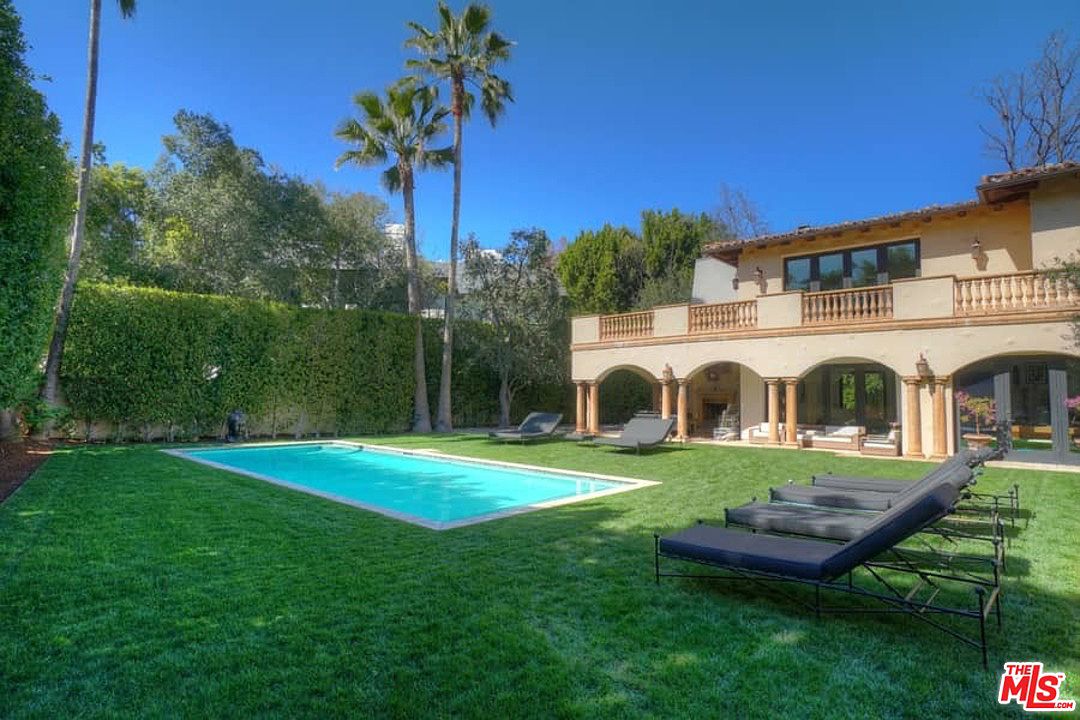 A large pool in the middle of a yard.