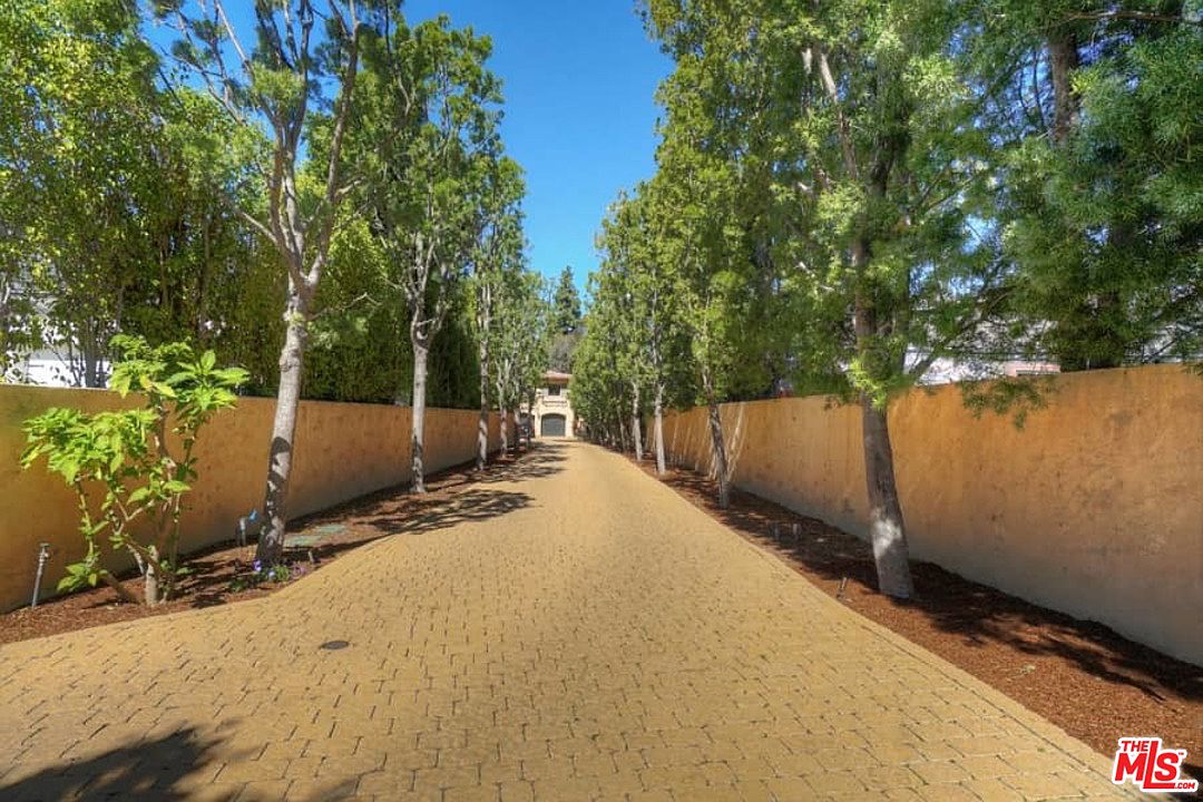 A road with trees and a fence on the side.