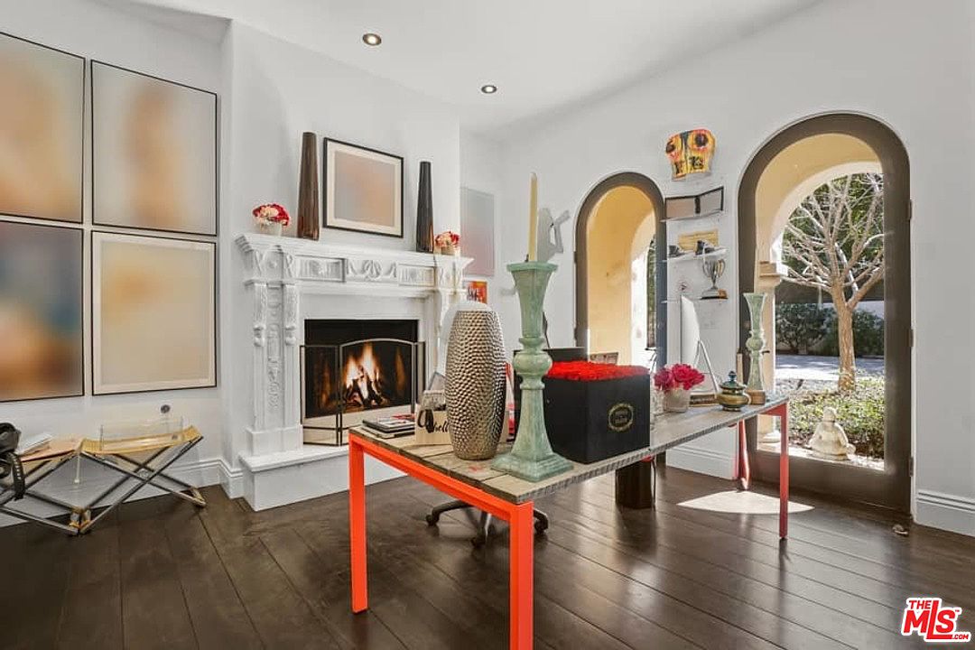 A living room with a fireplace and a table