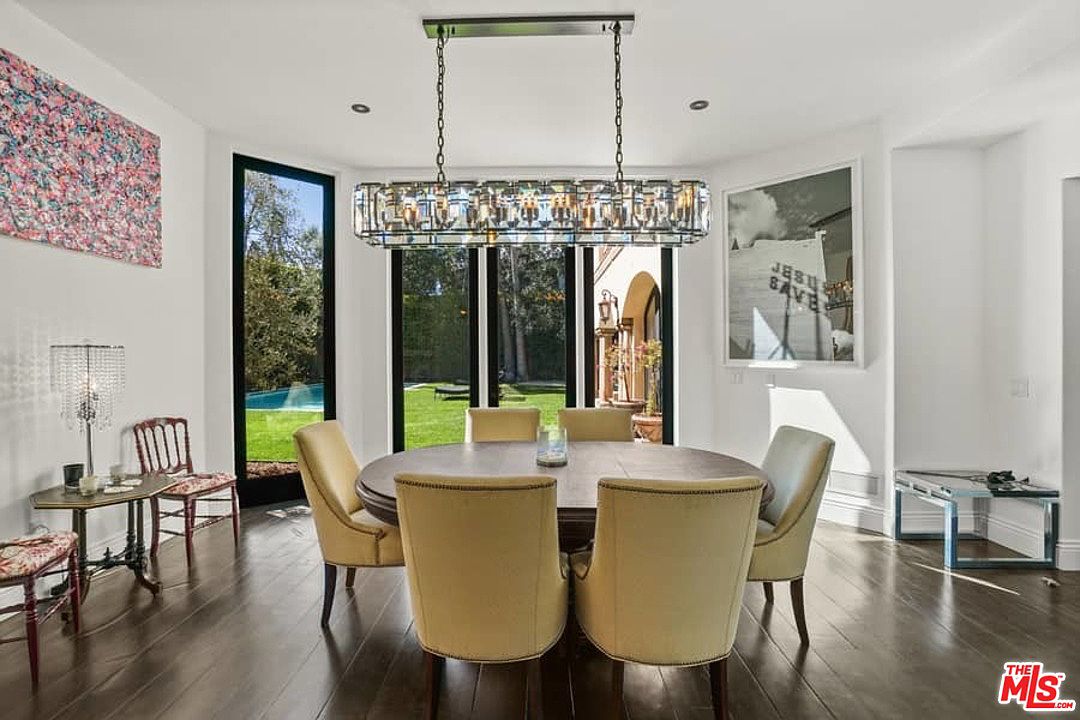 A dining room with a table and chairs in it