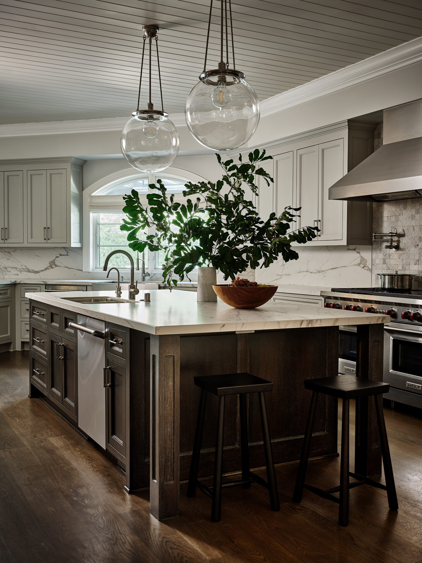 A kitchen with a large island and wooden cabinets.