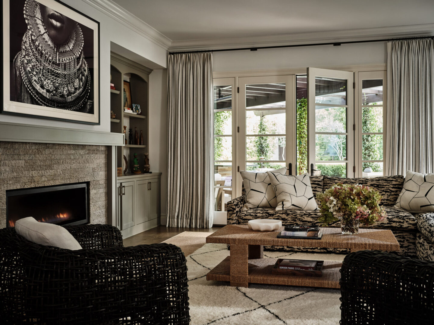 A living room with a couch, chair and fireplace.