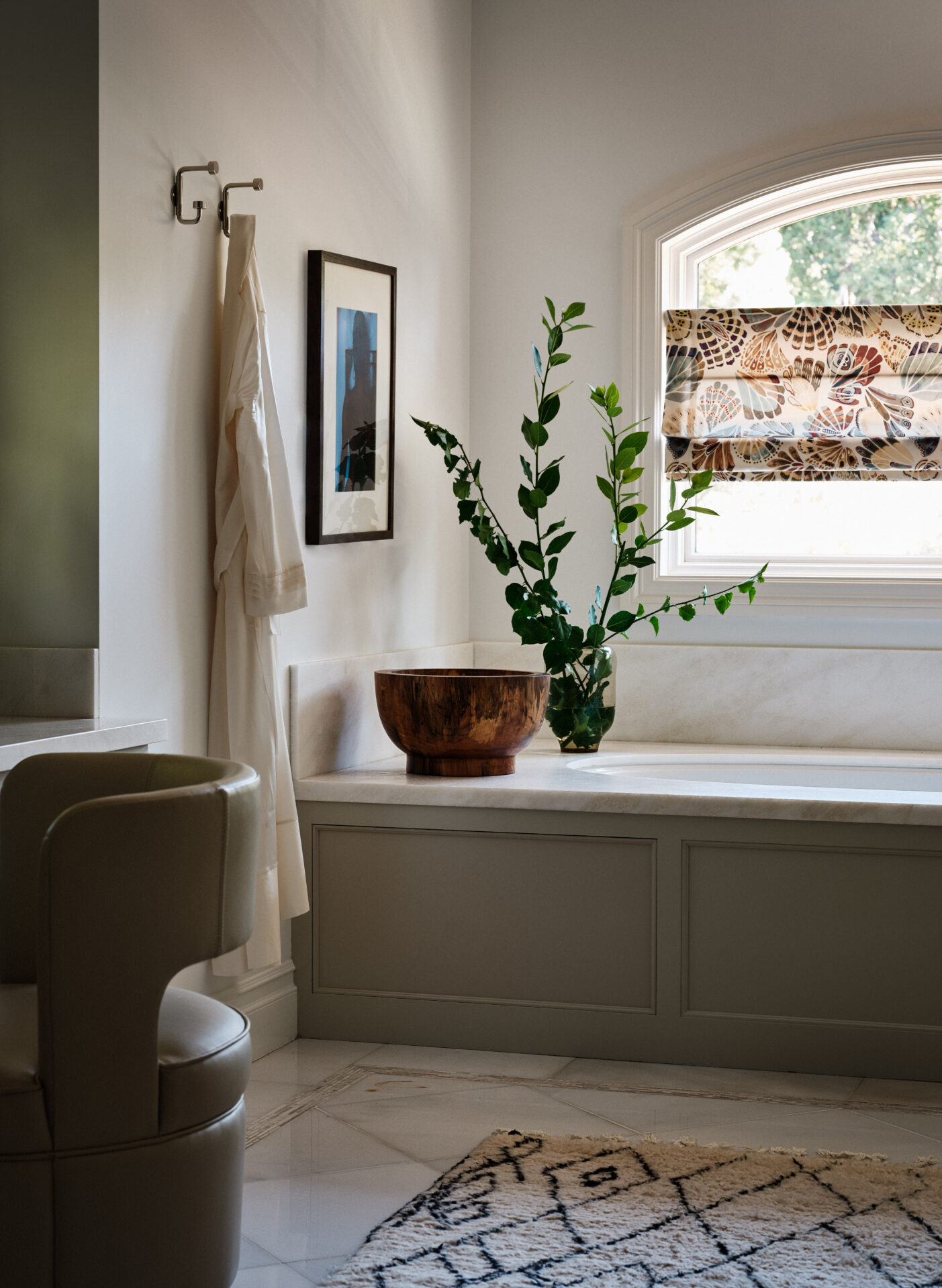 A bathroom with a tub, toilet and window.