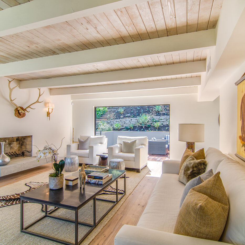 A living room with couches and tables in it