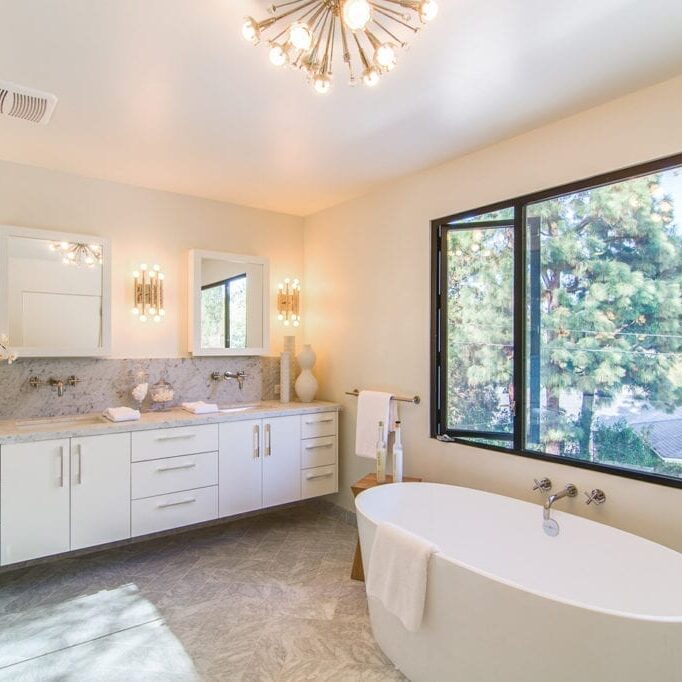 A bathroom with a large tub and sink.